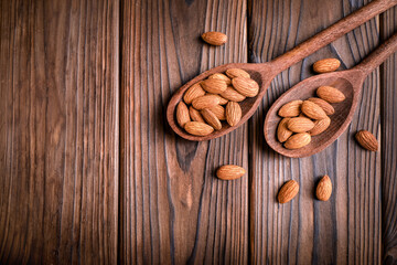 Almond nuts in wooden spoons