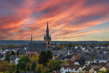 
View of the cathedral of Kiedrich / Germany in the Rheingau with a dramatic red discolored evening sky