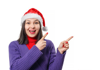 Portrait of a happy woman in a Christmas cap. Indicates an empty space for a copyspace. Isolated on white background.
