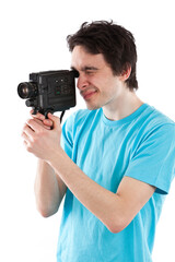 Studio photo of dark haired man with light blue t shirt using an old style camcorder. Isolated on white background.