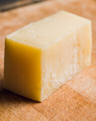 Tasty parmesan cheese on the rustic background. Selective focus. Shallow depth of field.