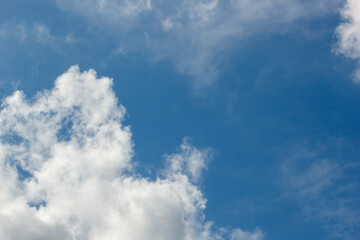 cumulus and high-cumulus clouds of an average tier on blue heavenly space