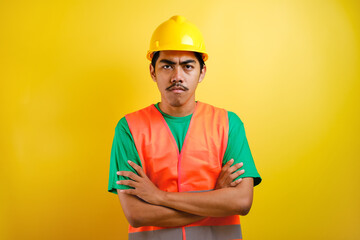 Young handsome asian indian worker man looked angry with crossed arm