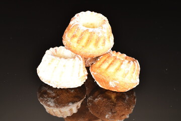 Fragrant sweet cupcakes, close-up, on a black background.