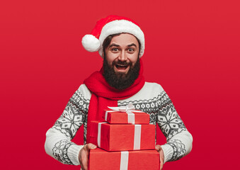 Happy bearded man carrying Christmas gifts