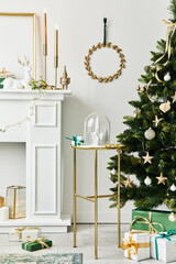 Stylish christmas composition at living room interior with white chimney, christmas tree and...