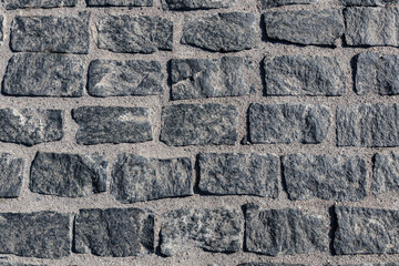 Old paving stone texture. Coddlestone sidewalk top view. Cobble block street architecture. Rough brick mosaic exterior. Squra textured granite backdrop. Pave rock way ground