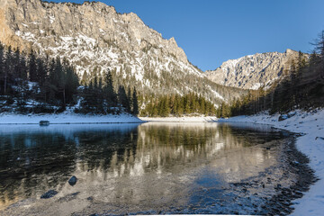 Peaceful mountain view with famous green lake in Austria Styria. Tourist destination lake Gruner See in winter. Travel spot situated in Tragos in lime stone Alps of Hochschwab.