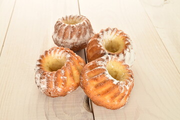 Fragrant sweet cupcakes, close-up, on a white wooden table.