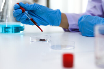 Scientist holding Coronavirus covid-19 infected blood sample tube DNA testing of the blood in the laboratory with blood sample collection tubes and syringe Coronavirus Covid-19 vaccine research.