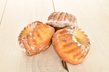 Fragrant sweet cupcakes, close-up, on a white wooden table.