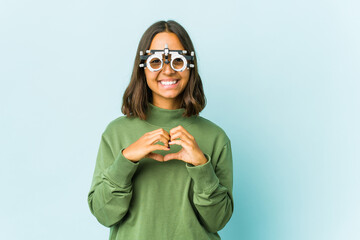 Young oculist latin woman over isolated background