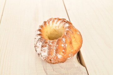 Fragrant sweet cupcakes, close-up, on a white wooden table.