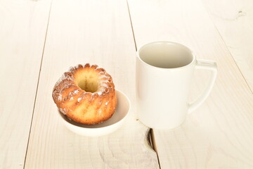 Fragrant sweet cupcakes, close-up, on a white wooden table.