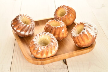 Fragrant sweet cupcakes, close-up, on a white wooden table.