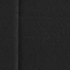 Black vintage rough sheet of carton. Recycled environmentally friendly cardboard paper texture. Simple gray minimalist papercraft background.