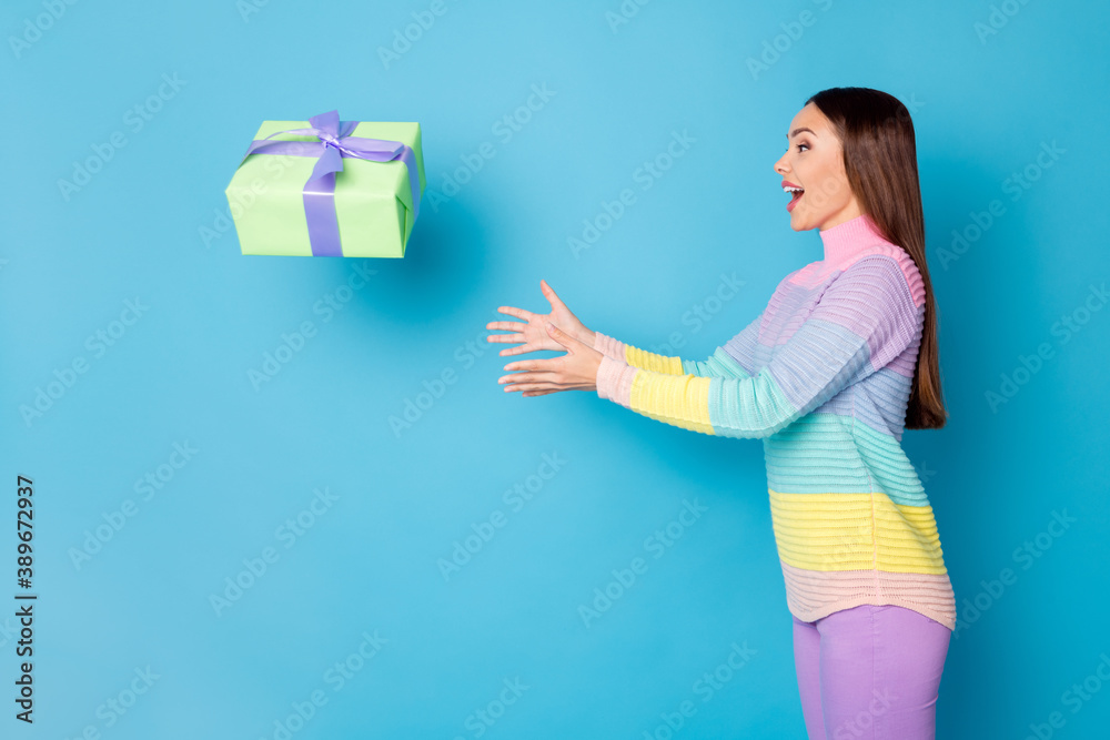 Poster Profile side photo of astonished girl get gift box air fly catch wear trousers sweater isolated blue color background