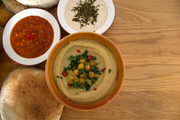 Israeli food close up photo. Falafels, hummea and pita bread on a table. 