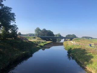 Fototapeta premium Road over a canal around Donkerbroek