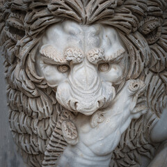 Fototapeta na wymiar Ancient figure of a fearful lion killing a zebra in Rome, Italy, closeup, details.