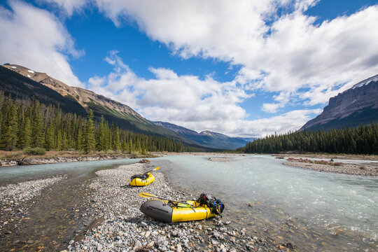 Scenic view of two packrafts on river bank in Banff National Park.