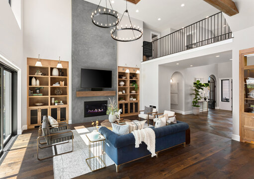 Living room in new luxury home with floor to ceiling fireplace s