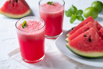 Watermelon smoothie topping with fresh mint leaves on wood background