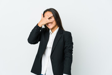 Young asian bussines woman isolated on white background blink at the camera through fingers, embarrassed covering face.