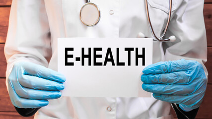 The doctor's blue - gloved hands show the word E-HEALTH - . a gloved hand on a white background. Medical concept. the medicine