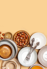 Many different ceramic dishes on a beige background top view. Flat lay. Free space for text. Frame of empty ceramic plates and bowls. Copy space.