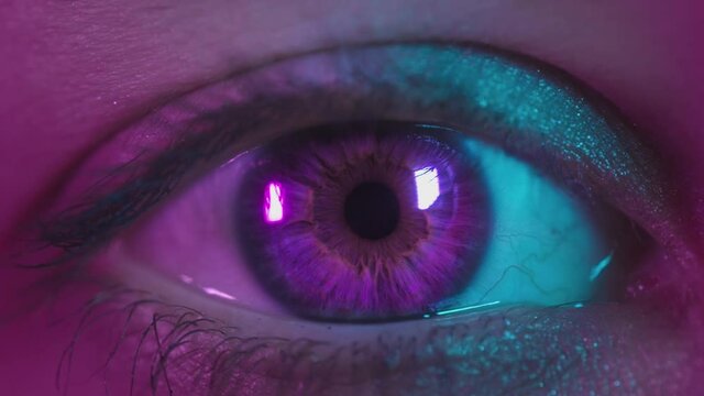 Close Up Shot Of Eye Opening With Pink Iris. Healthy Eyesight Concept. Female Pink Eye In Neon Light. Young Sexy Girl In A Nightclub. Macro Look Of The Human Eye. Pink-blue-green Color, Euphoria.