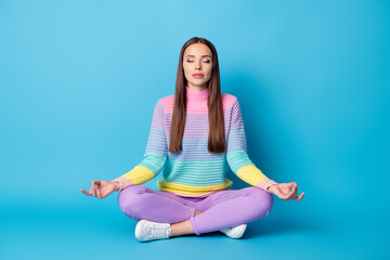 Portrait of lovely dreamy calm girl sitting lotus position crossed legs meditating isolated on...
