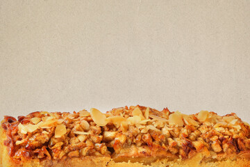 Sweet short crust pastry. Pie with apples and pistachios. Old paper textured image with copy space