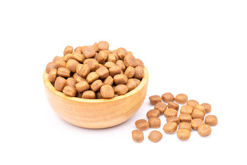 Pile of dog food in wooden bowl isolated on white
