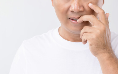 Nail Biting (Onychophagia) concept : Portrait people biting his nail. Studio shot isolated on grey