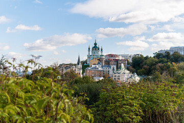 Fototapeta na wymiar Kyiv (Kiev), Ukraine - October 8, 2020: Stunning view on the old and ancient tourist area in Kyiv, Saint Andrew's Church with prerevolutionary residential buildings