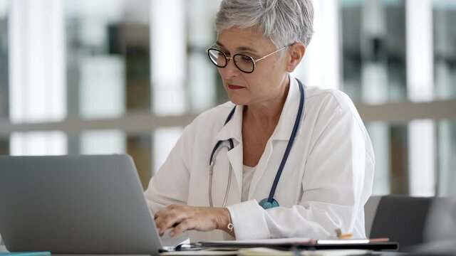 Portrait of mature woman doctor with eyeglasses working in hospital office