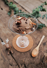 Chocolate ice cream in a glass placed on a wooden table