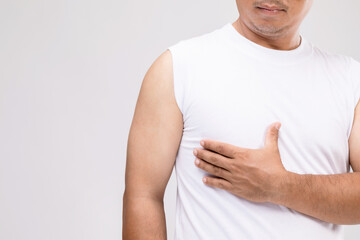 Breast cancer in men concept : Portrait Asian man in posture of care or protect himself from ...