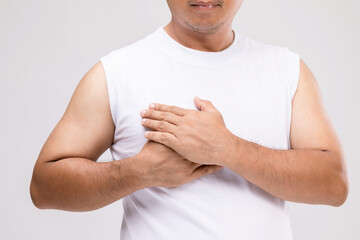 Breast cancer in men concept : Portrait Asian man in posture of care or protect himself from  breast cancer. Studio shot isolated on grey