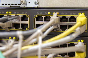 Network hardware. Optical fiber. White cables connect to network equipment. Server close-up....