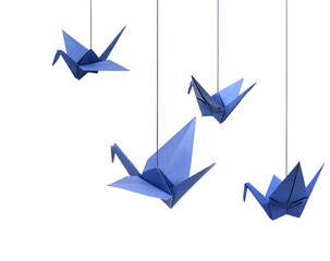 a haning blue origami bird paper on white