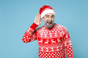 Excited Northern bearded man frozen icy face in Santa hat Christmas sweater try to hear you...