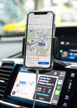 BANGKOK, THAILAND-27 October, 2020: Google Maps app with Apple CarPlay on car screen dashboard and iPhone, smart UI mobile application for travel navigation and vehicle transportation safety