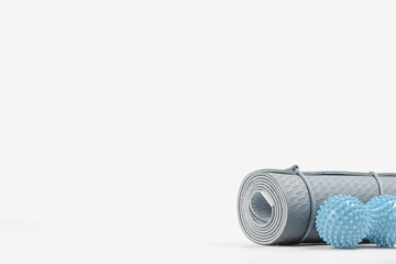 Rolled blue yoga mat and double massage ball. Gender neutral fitness and exercise concept accessories with copy space. Active lifestyle. Workout at home or gym, sports club poster