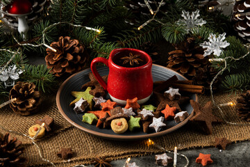Hot tea on a red cup and Christmas cookies with a star and snowman shape
