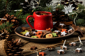 Hot tea on a red cup and Christmas cookies with a star and snowman shape