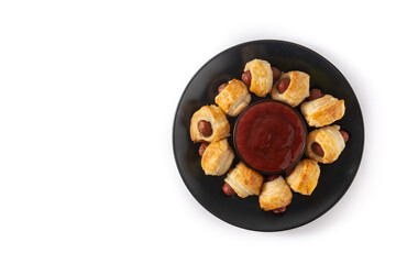 Pigs in blankets. Mini sausages wrapped in puff pastry with ketchup sauce isolated on white background. 