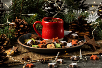 Hot tea on a red cup and Christmas cookies with a star and snowman shape