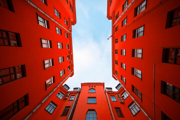 Red house with residential apartments, building with red facade, creativity picture 